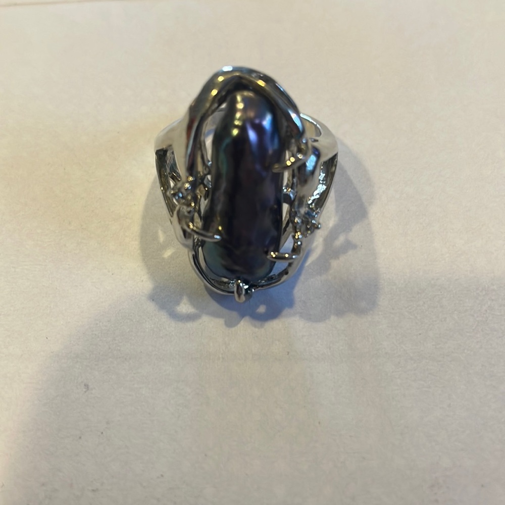 Large fashion ring with piece is iridescent shell. Size 6